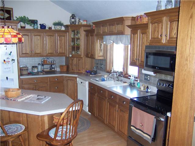 Red oak cabinets - Raised panel doors - Standard overlay style - Laminate countertops